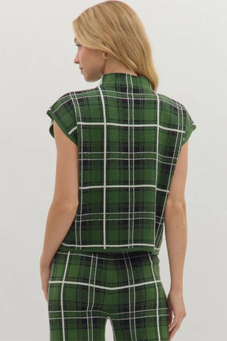 Person wearing a green plaid outfit on a white background
