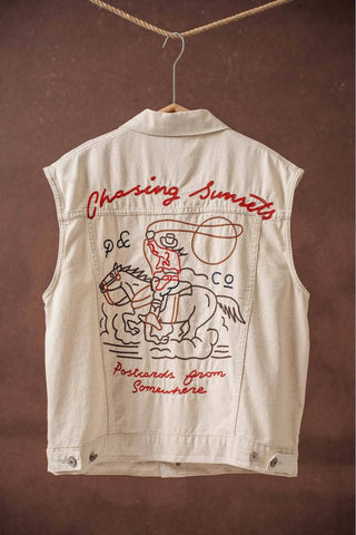 Beige vest with red embroidered text and graphics on a brown background