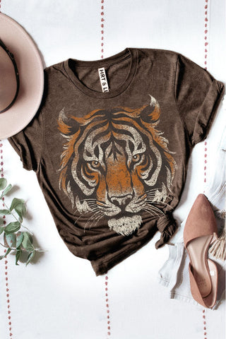 Brown t-shirt with tiger graphic on a white surface with decorative elements