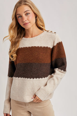 Woman wearing a striped sweater with a neutral background