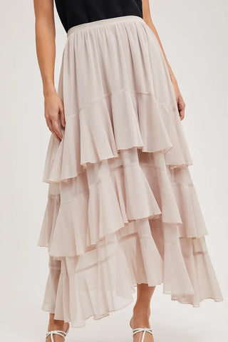 Beige layered skirt worn by a person on a white background