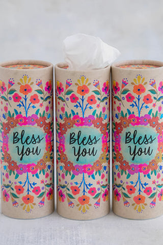 Three cylindrical containers with floral designs and 'Bless You' text on a white background