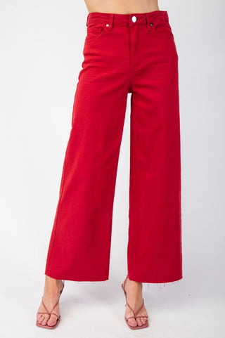 Red pants worn by a person on a white background